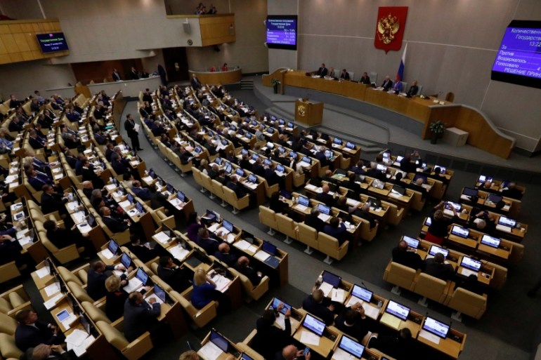 Russian lawmakers attend a session during a vote for the pension reform bill at the State Duma in Moscow