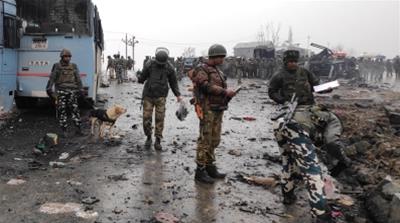 Indian soldiers examine the debris after the deadly explosion in Pulwama [File: Younis Khaliq/Reuters]