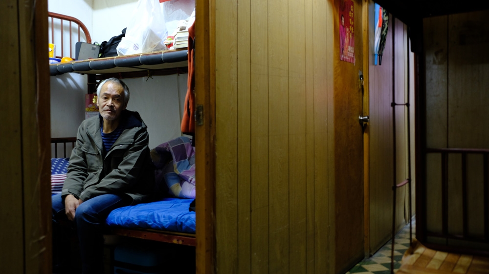 Wong Sai-lok, 59, lives in a 40-square-foot subdivided unit with a shared bathroom and kitchen [Yupina Ng/Al Jazeera]