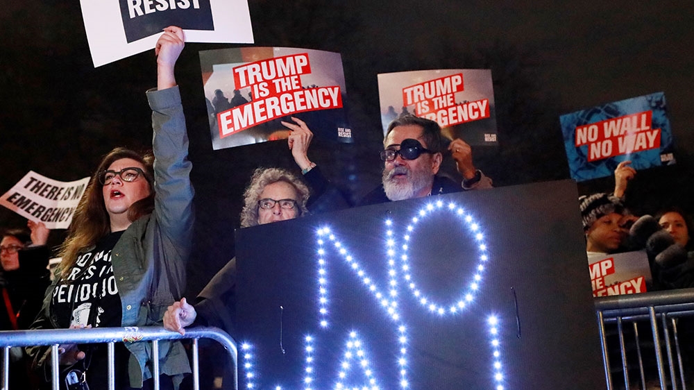 People gather during a protest against US President Donald Trump's declaration of a national emergency to build a border wall [Andrew Kelly/Reuters] 