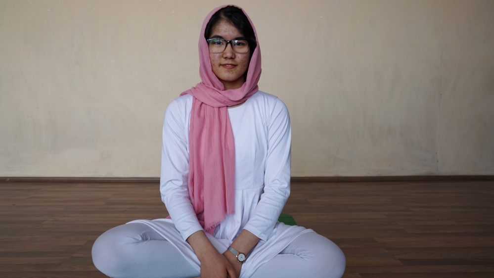 Froohar Momtaz helps her mother run the yoga studio [Sorin Furcoi/Al Jazeera]