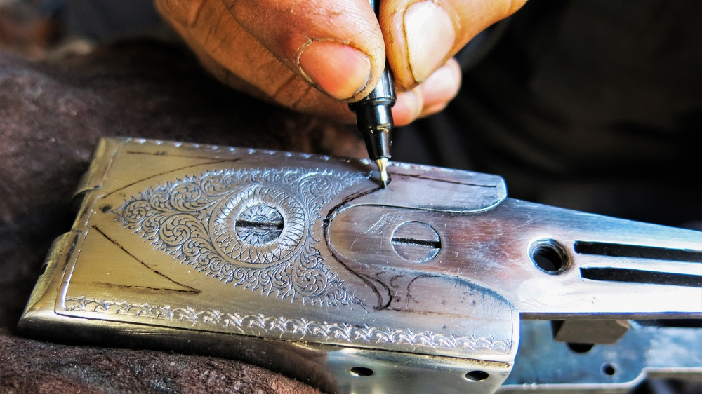Craftsmen include master engravers, whose work is mostly used on expensive hunting rifles [Asad Hashim/Al Jazeera]