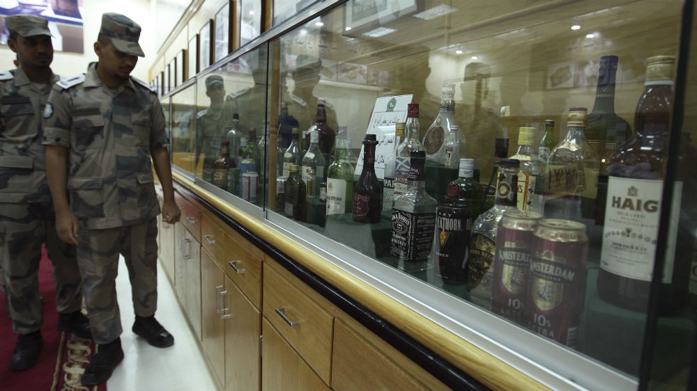 Students training in the Drug and Poison Division at the King Fahad Security College look at a collection of bottles of alcohol confiscated by Saudi security forces in the past [File: Fahad Shadeed/Reuters]