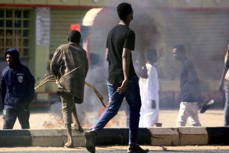FILE PHOTO: Sudanese demonstrators light a fire as they participate in anti-government protests in Khartoum