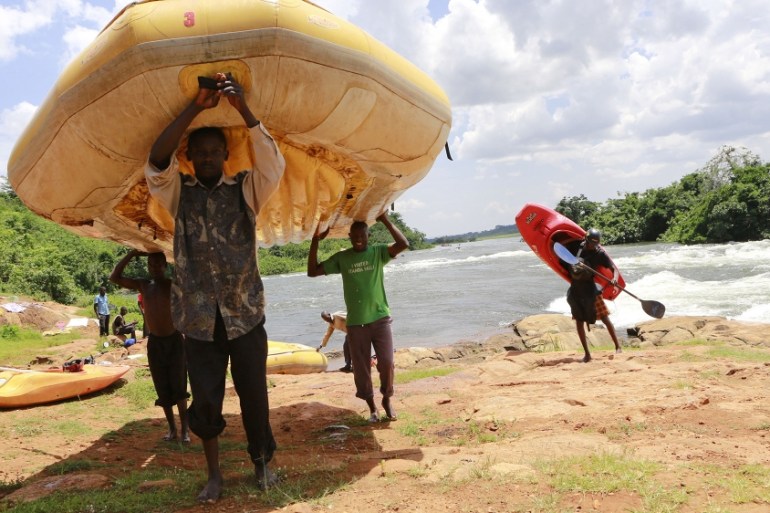 Men carry rafts and kayaks used during white water rafting at Itanda falls on the River Nile near Jinja district, 109km (68 miles) east of the Ugandan capital of Kampala, October 19, 2013.James Akena