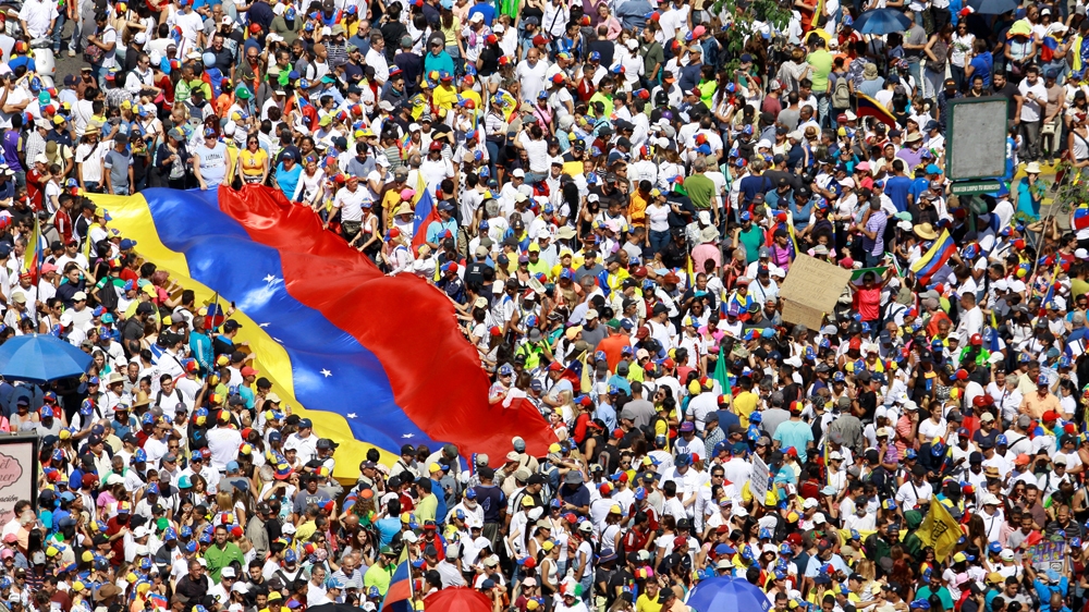 
Guaido and Maduro are holding competing rallies in the capital, Caracas, on Saturday. [Adriana Loureiro/Reuters]
