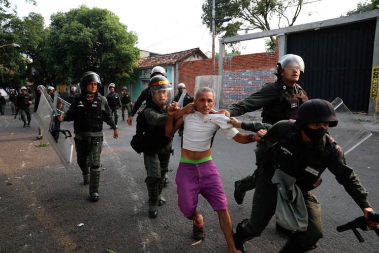 A man is detained during clashes with the Bolivarian National Guard in Urena, Venezuela, near the border with Colombia, Saturday, Feb. 23, 2019. Venezuela''s National Guard fired tear gas on residents