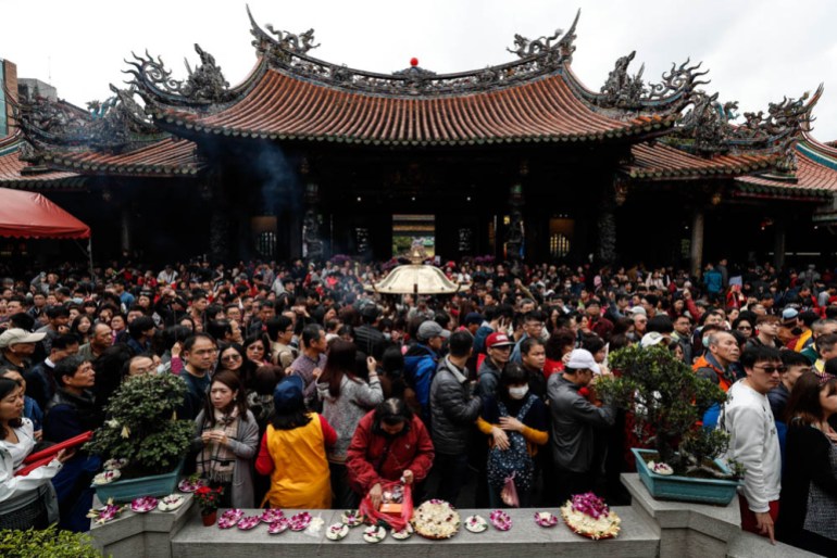 People pray, offer flowers and food inside the Lungshan Temple during the Chinese New Year celebration in Taipei, Taiwan, 05 February 2019. The Chinese New Year, or Year of the Pig, begins on 05 Febru