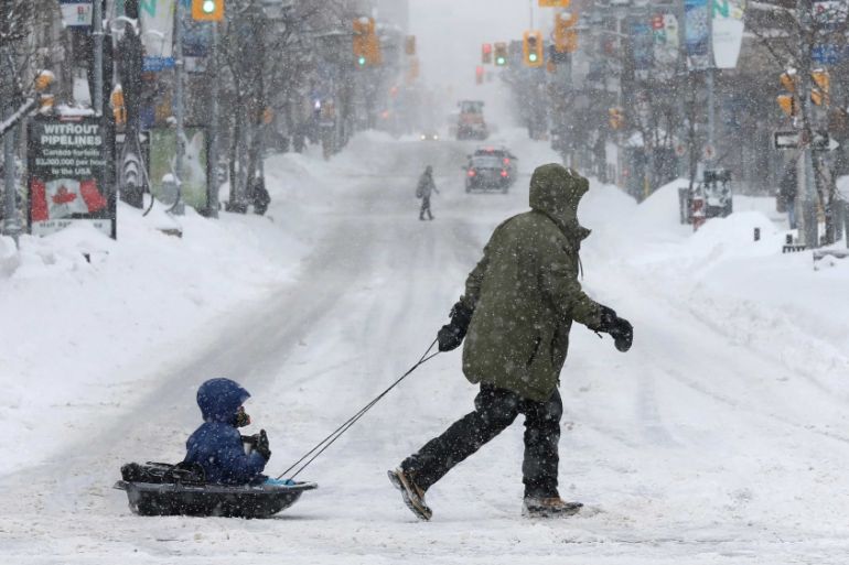 Appropriate transport for a child during a winter snow storm in Ottawa, Ontario, Canada.