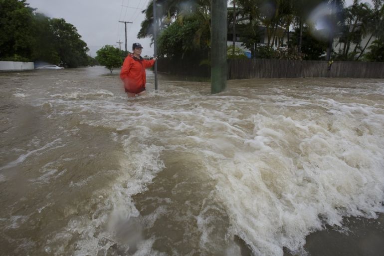 Amelia Rankin stands in flooded waters in Hermit Park, Townsville, Queensland, Australia