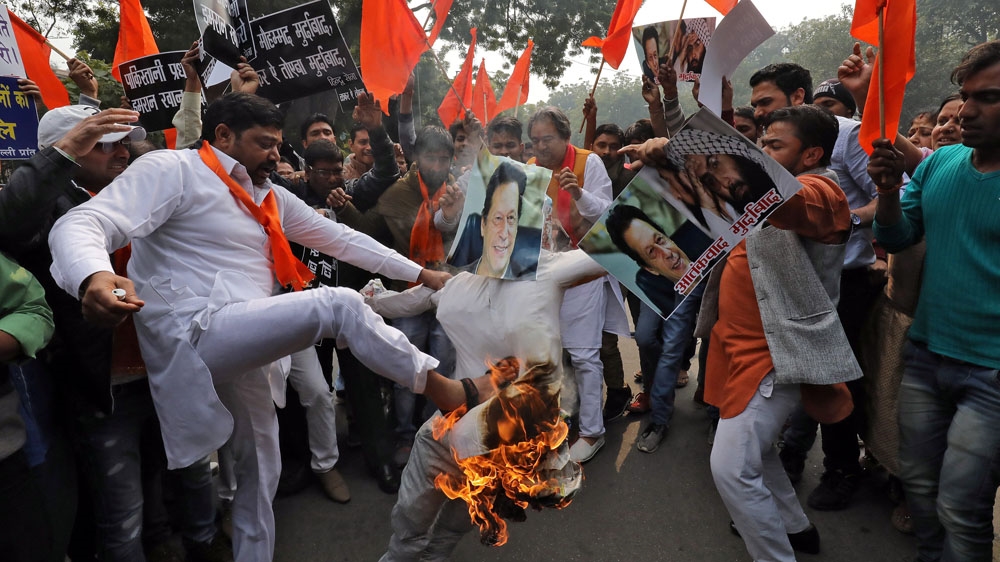 Members of Hindu Sena, a right-wing Hindu group, burn an effigy depicting Pakistan's PM Imran Khan in New Delhi [Anushree Fadnavis/Reuters]