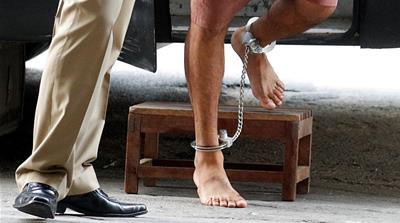 Hakeem al-Araibi walked off the prison bus barefoot, his feet shackled [Jorge Silva/Reuters]
