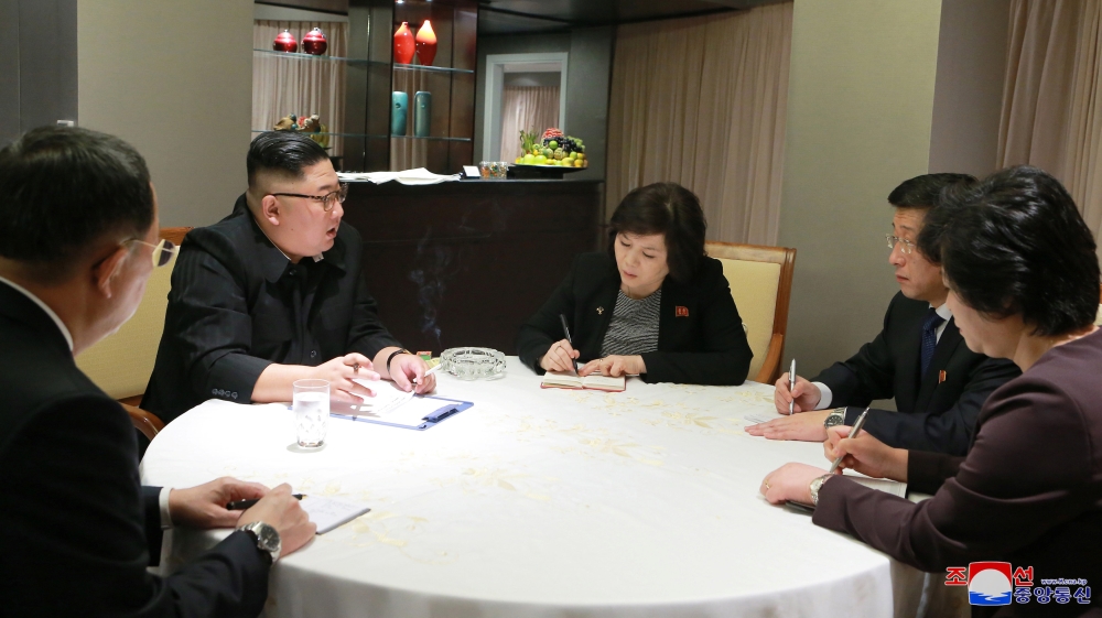Kim receives a briefing after his arrival in Hanoi [KCNA via Reuters]