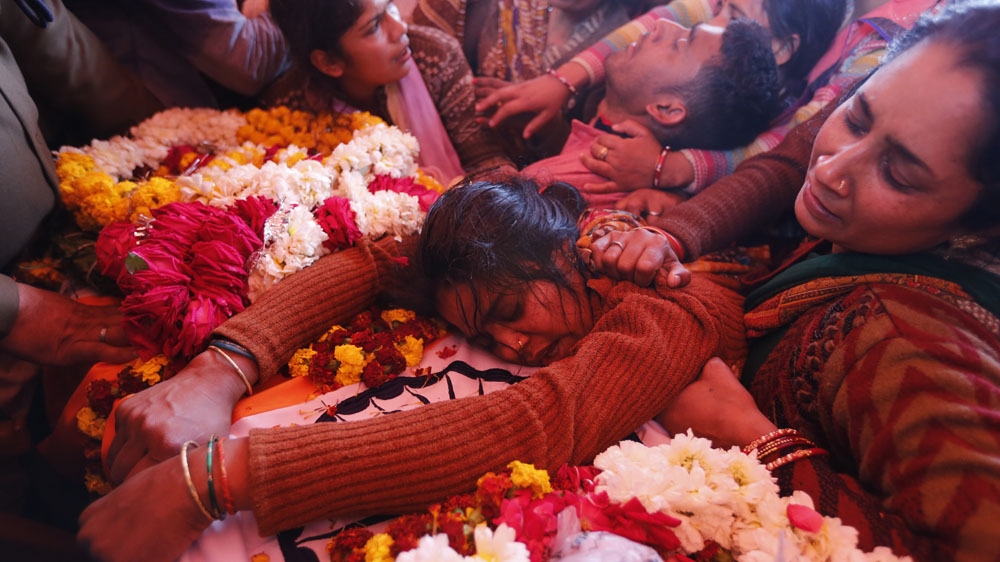 Sanjana cries over the body of her husband Mahesh Yadav, a CRPF trooper killed in Thursday blast, in Tudihar village of Prayagraj in Uttar Pradesh [Rajesh Kumar Singh/AP]