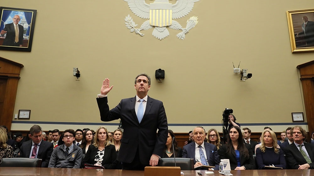 Michael Cohen is sworn in to testify at a hearing on Capitol Hill [File: Jonathan Ernst/Reuters] 