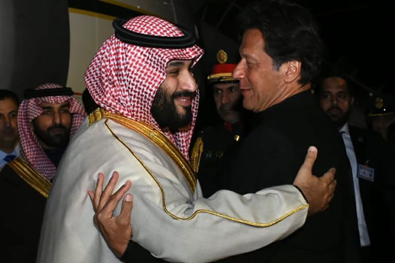 In this handout photograph taken and released by Pakistan''s Press Information Department (PID) on February 17, 2019, Pakistan''s Prime Minister Imran Khan (R) greets Saudi Arabian