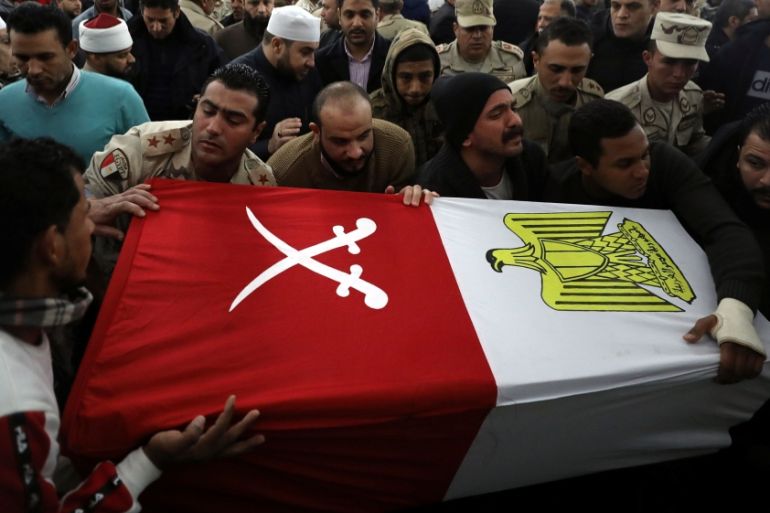 Mourners and members of security forces carry a coffin containing the body of Egyptian military officer Abdulrahman Ali Mohammed during his funeral, in Cairo