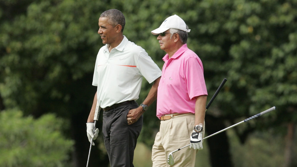 Najib playing golf with then-US President Barack Obama in Hawaii in December 2014 [File: Hugh Gentry/Reuters]