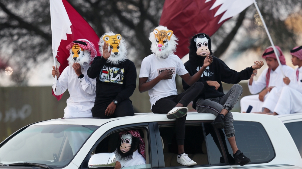 Qatari fans celebrate after winning the AFC Asian Cup at the Doha Corniche [Ibraheem al Omari/Reuters]