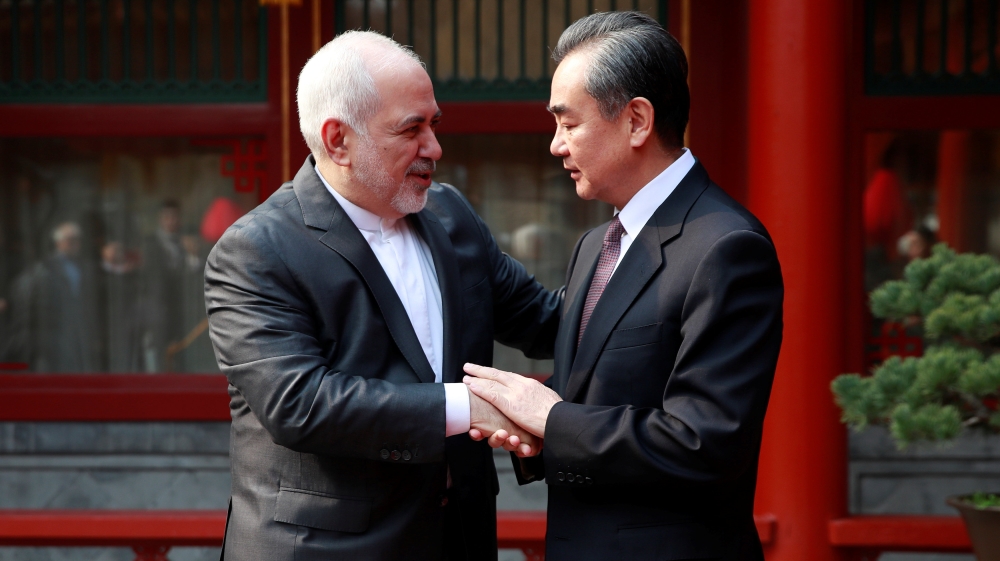 Chinese Foreign Minister Wang Yi (right) meets his Iranian counterpart Mohammad Javad Zarif in Beijing [How Hwee Young/Pool via Reuters]