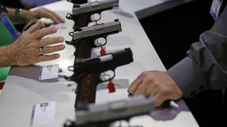 Guns sit on display at the NRA annual convention where President Donald Trump is scheduled to speak later in the day in Atlanta, Friday, April 28, 2017. (AP Photo/David Goldman)