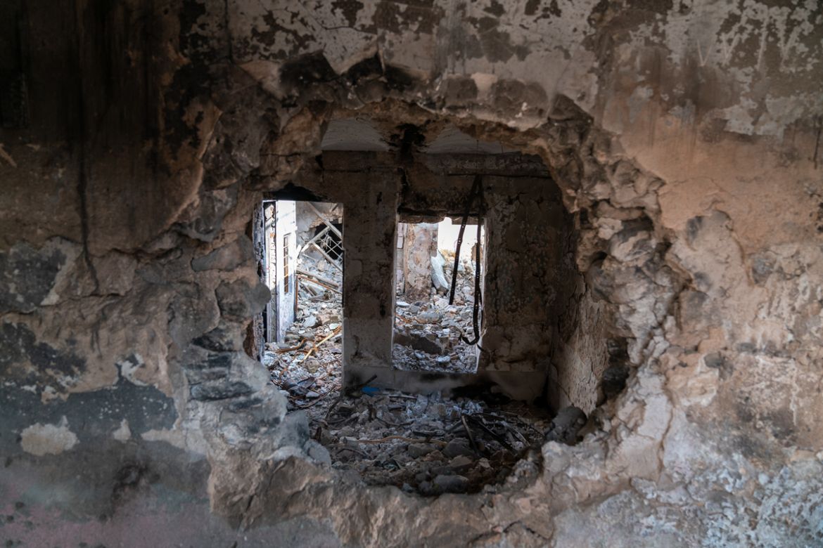 Islamic State fighters blew large holes between buildings so that they could move freely from one to another during coalition airstrikes. [Emre Rende/Al Jazeera]