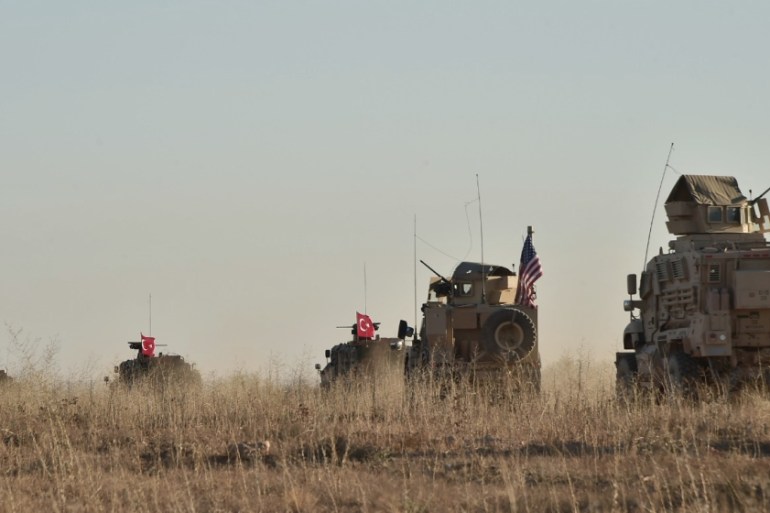 Turkish and U.S. troops conduct joint patrols around the Syrian town of Manbij,
