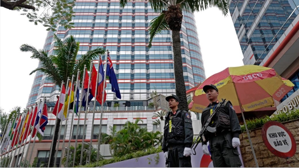 Police officers stand guard outside Melia Hotel in Hanoi [Vincent Yu/AP Photo]