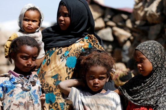 Children stand at a makeshift camp for internally displaced people near Sanaa, Yemen