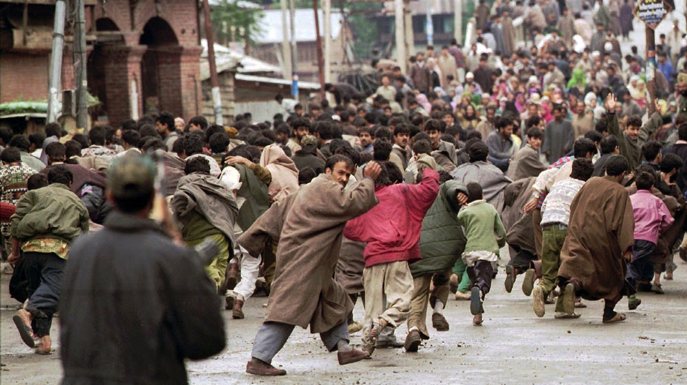 May 23, 1996 - Kashmiri protesters flee from Indian security forces after their procession, held against the first parliamentary elections held in much of Kashmir valley, was broken up in Baramulla, India-administered Kashmir. [John Moore/The Associated Press]