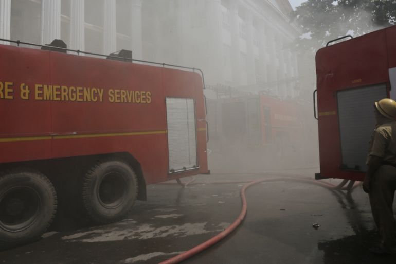 In- A firefighter stands by a fire engine at Calcutta Medical College and Hospital in Kolkata, India, Wednesday, Oct. 3, 2018.