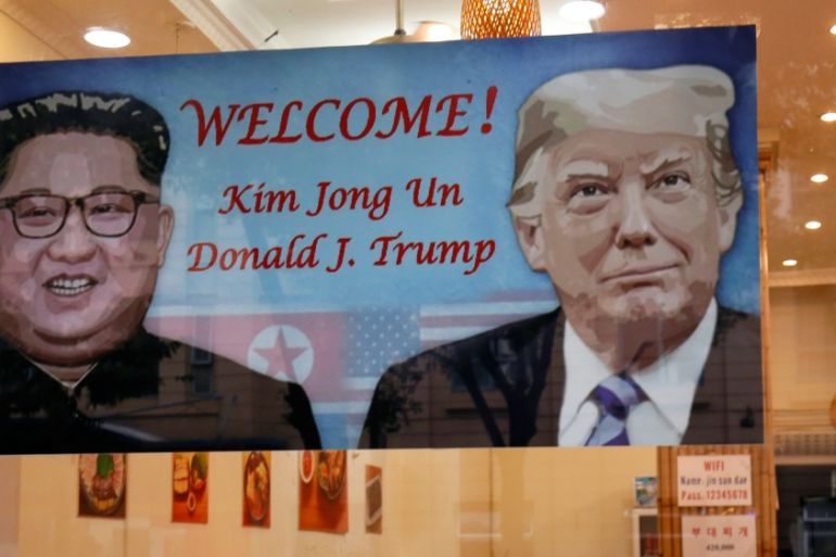 A welcoming banner with images of U.S. President Donald Trump and North Korean leader Kim Jong Un hangs at a South Korean restaurant ahead of USA-DPRK summit in Hanoi