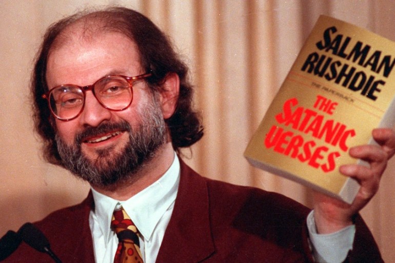 Salman Rushdie holds a copy of The Satanic Verses