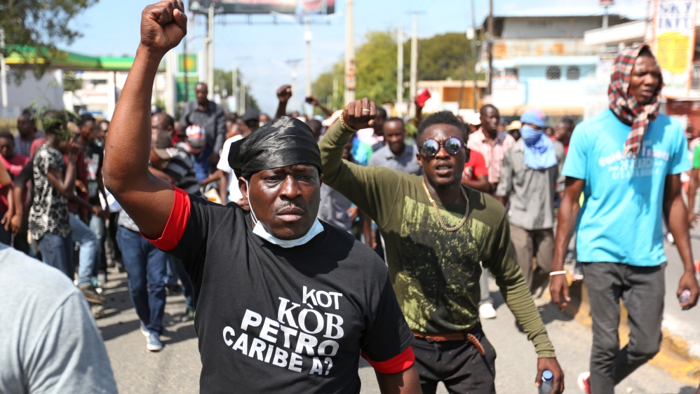 Demonstrators take part in a protest against officials accused of misusing Petrocaribe funds [Jeanty Junior Augustin/Reuters]