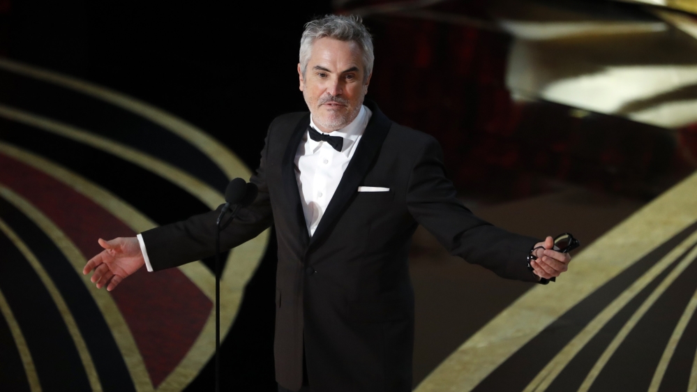 Alfonso Cuaron speaks on stage after accepting the Best Director award for Roma [Mike Blake/Reuters]