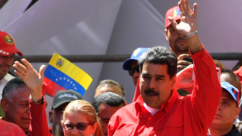 Maduro gestures during a pro-government march in Caracas [File: Yuri Cortez /AFP]