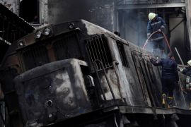 Rescue workers put out a fire at the main train station in Cairo
