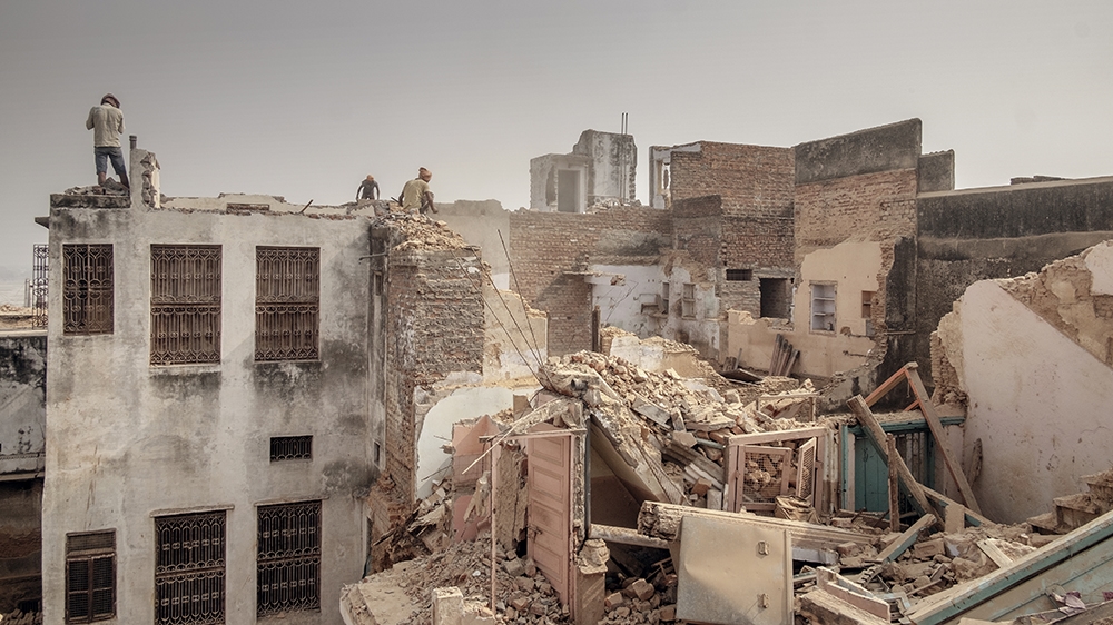 Contractors are seen demolishing houses to make way for the newly planned Kashi-Vishwanath Corridor, leading from the temple to the Ganges River [Andrea de Franciscis/Al Jazeera]