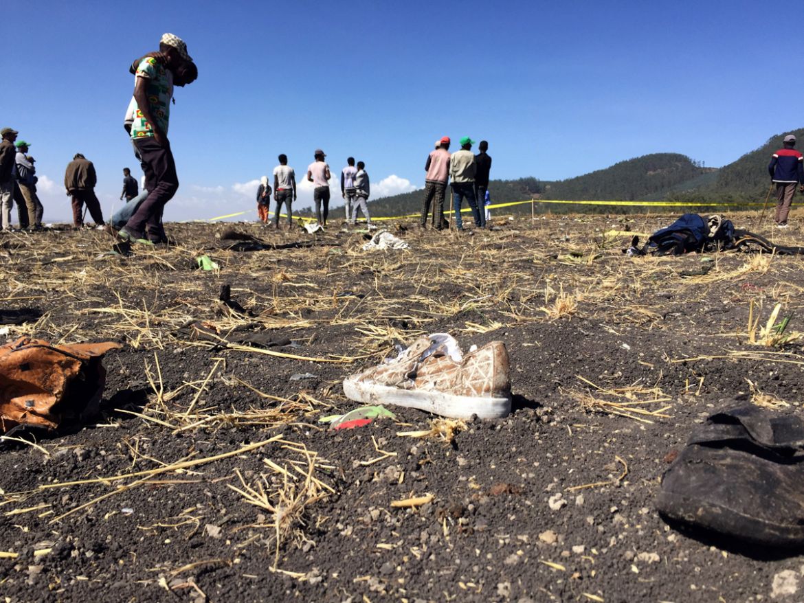 People walk at the scene of the Ethiopian Airlines Flight ET 302 plane crash, near the town of Bishoftu, southeast of Addis Ababa, Ethiopia March 10, 2019. REUTERS/Tiksa Negeri - RC18309A21B0