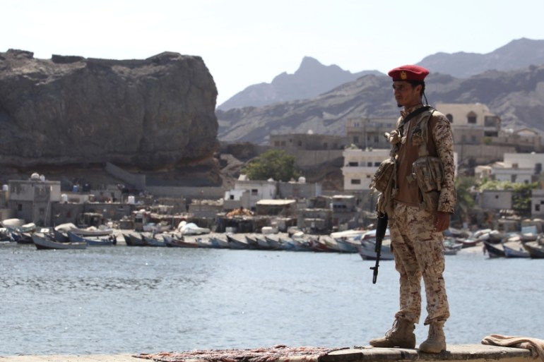 A soldier allied to Yemen''s internationally recognized government stands guard at the fish market in Aden