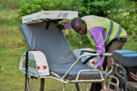 Paul Hamba a Village Health Team member in Budondo sub county preparing his ambulance carrier. E-scooters are used in place of bicycles to access patients in hilly areas. Date 20th.03.2019