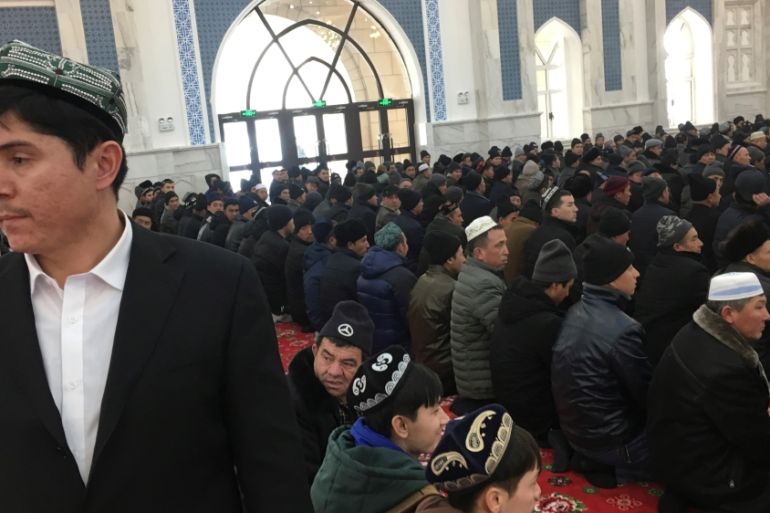 Men pray at the mosque at the Xinjiang Islamic Institute during a government organised trip in Urumqi