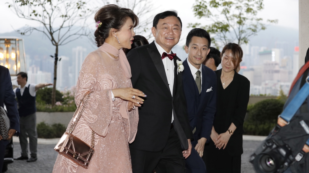 Thaksin Shinawatra, centre, accompanies Princess Ubolratana, centre left, as they arrive for the wedding of Thaksin's youngest daughter at a hotel in Hong Kong [Kin Cheung/ AP]