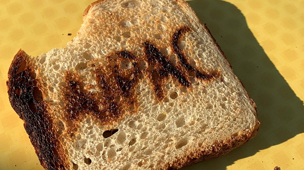 A few members of Jewish Voice for Peace held a protest on a street corner offering AIPAC-branded toast to passersby [William Roberts]