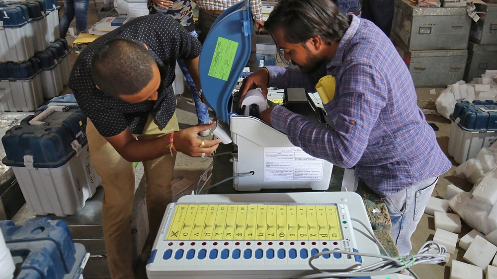 Election staff prepare Voter Verifiable Paper Audit Trail (VVPAT) machines and Electronic Voting Machines (EVM) ahead of India's general election [Amit Dave/Reuters]