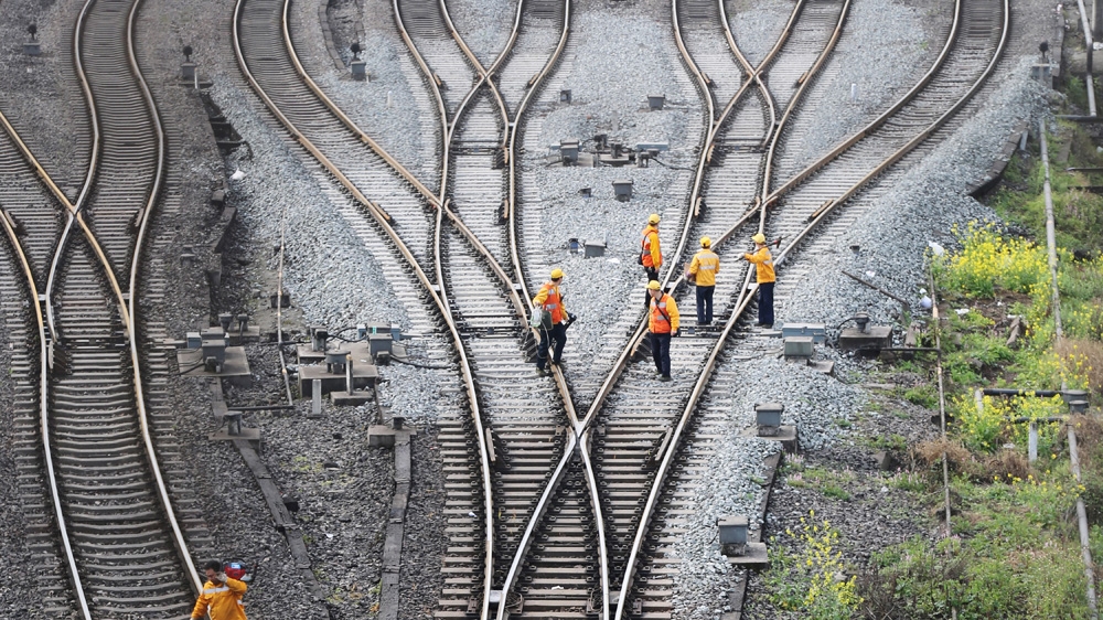 Workers inspect railway tracks, which serve as a part of the Belt and Road freight rail route linking Chongqing to Duisburg at Dazhou railway station in Sichuan province, China [Reuters]