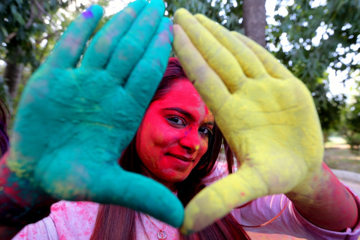 A college student poses as she takes part in the Holi festival celebrations in Bhopal, India, 19 March 2019. Holi is celebrated on the full moon day and marks the beginning of the spring season. Holi
