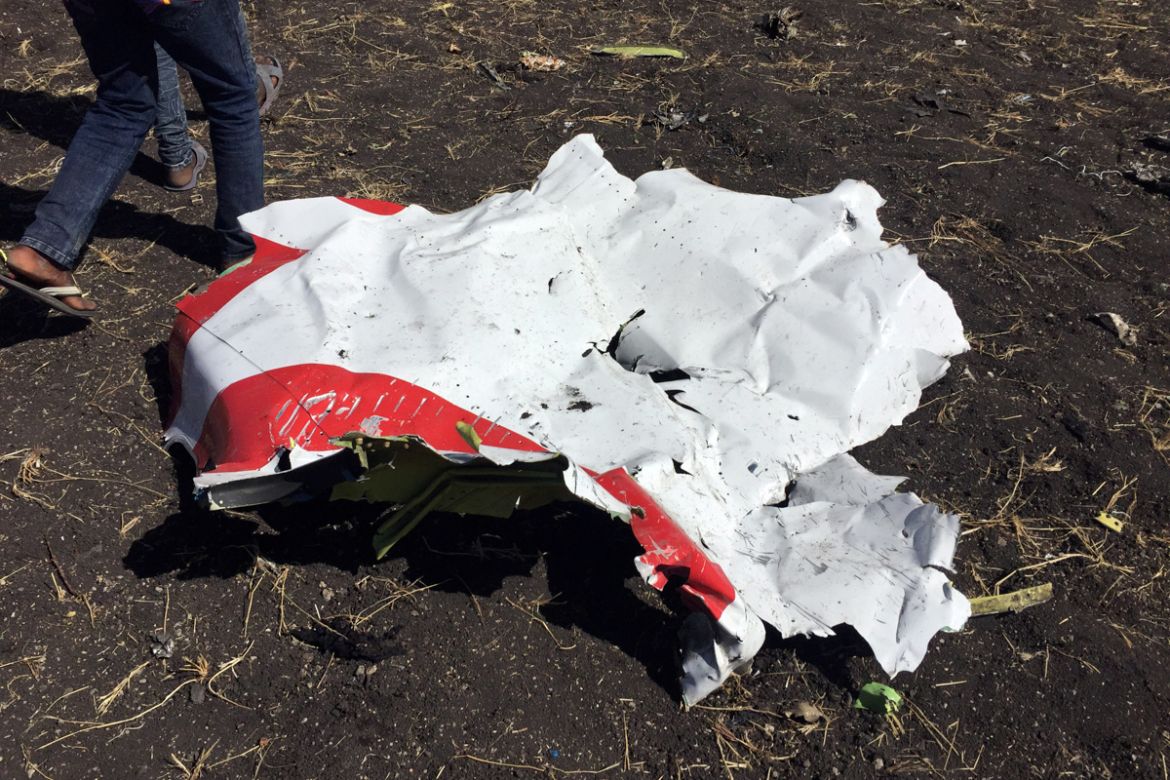 eople walk past a part of the wreckage at the scene of the Ethiopian Airlines Flight ET 302 plane crash, near the town of Bishoftu, southeast of Addis Ababa, Ethiopia March 10, 2019. REUTERS/Tiksa Neg