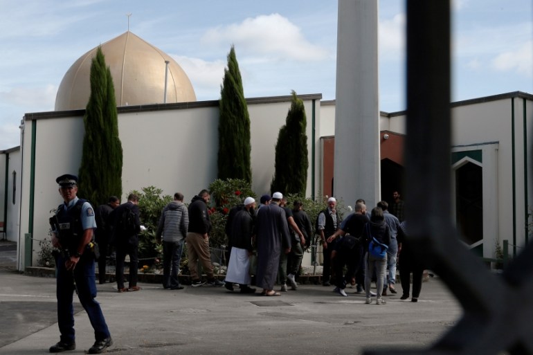 A policeman stands guard as members of the Muslim community visit Al-Noor mosque after it was reopened in Christchurch, New Zealand, March 23, 2019