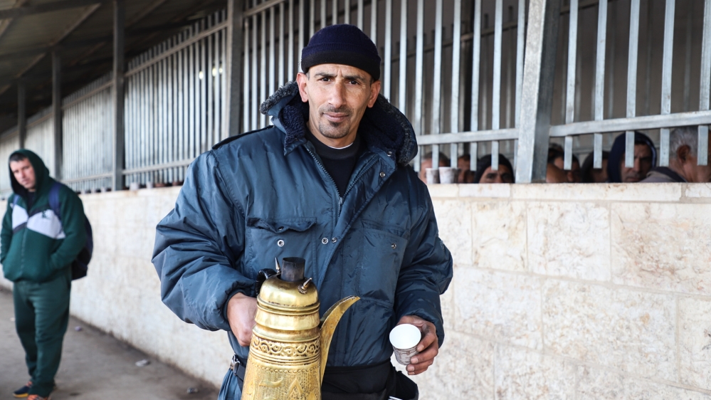 Abed Abu Shiera has sold coffee outside the checkpoint for 11 years [Jaclynn Ashly/Al Jazeera]